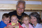Link to bio: Jon with 3 grandkids and wife, Mary